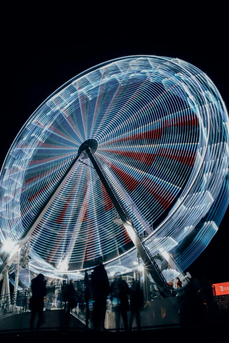 A ferris wheel at night with a long exposure